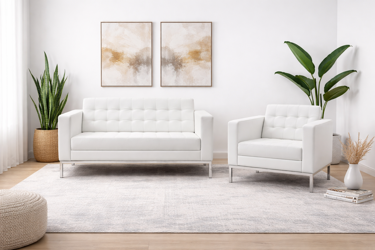 Modern white tufted sofa and matching armchair shown in a refined, upscale interior setting