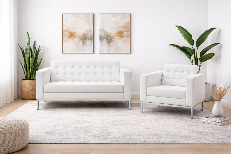 Modern white tufted sofa and matching armchair shown in a refined, upscale interior setting