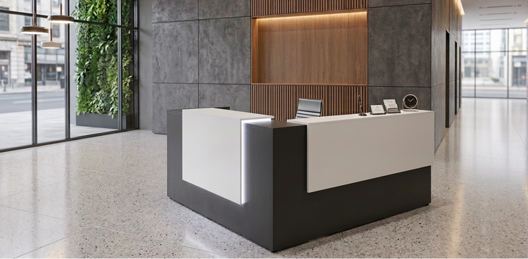 Modern reception desk in a stylish office lobby with glass walls and greenery.